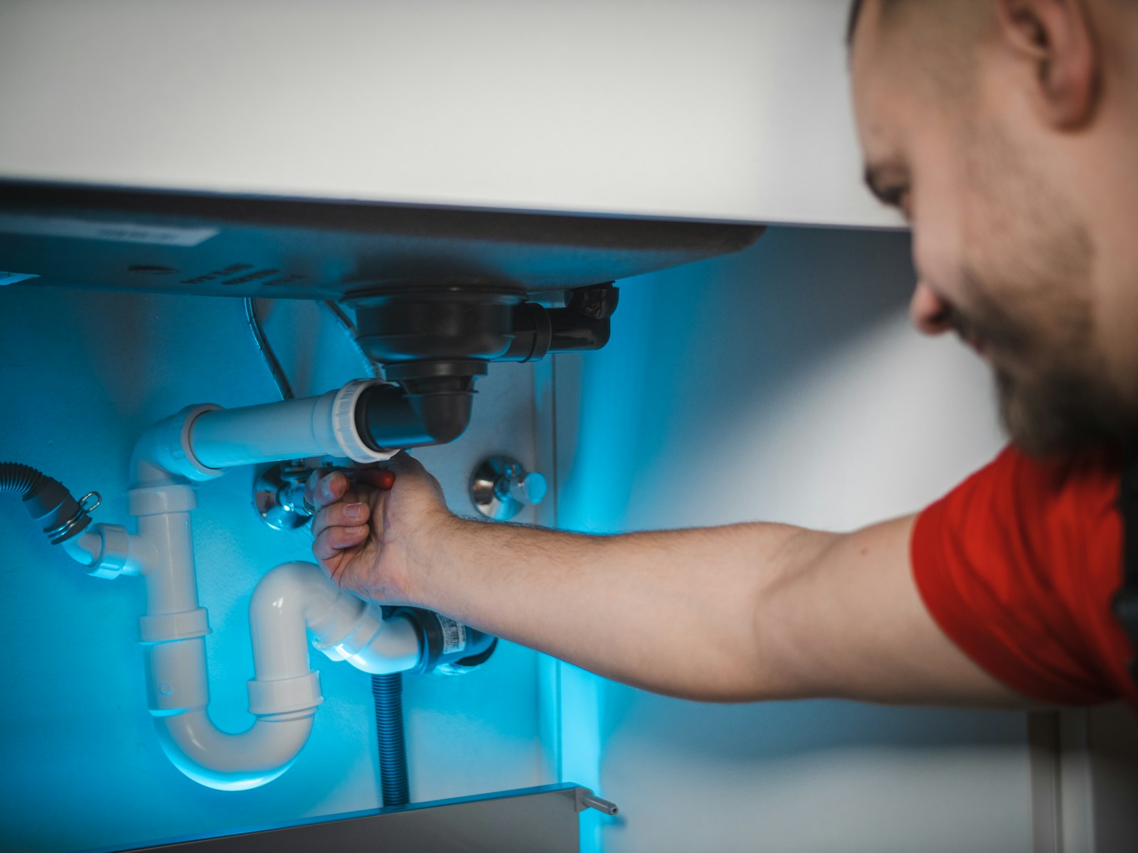 A plumber at work on a job